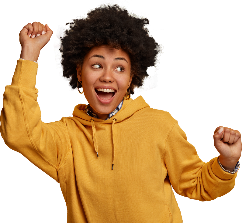 Happy woman in a yellow hoodie celebrating with raised hands.