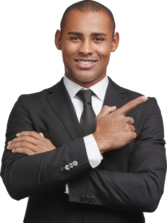 Confident businessman in a black suit pointing to the side with a smile.